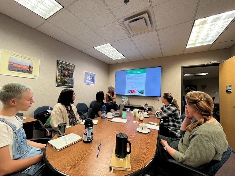 Jones labbers and RMRS friends look on as Lisa Bryant discusses the role of the Science Applications and Communications staff team.