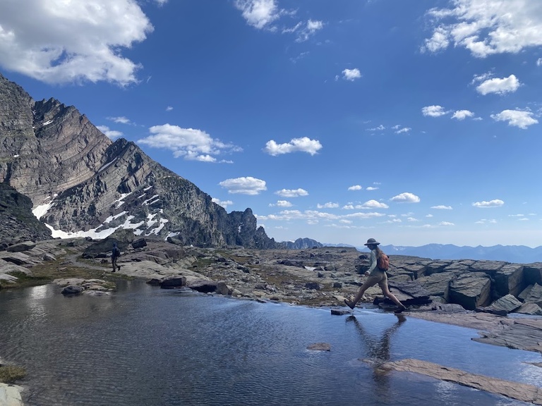 Rock-hopping along the edge of an alpine lake in Glacier National Park, MT.