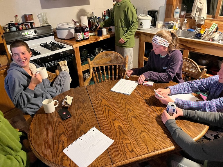 Team Pika shuffling the deck for a rousing night of Sheeps-head in the cabin.