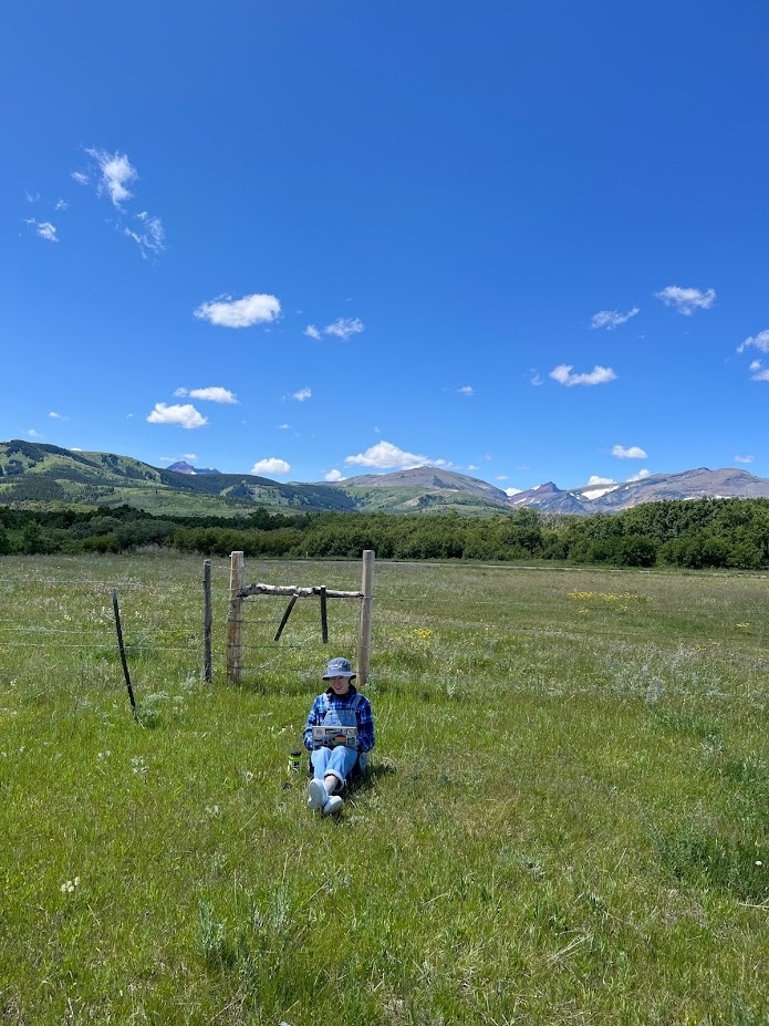 Jessalyn trying to get a whiff of cell service near the pika team cabin.