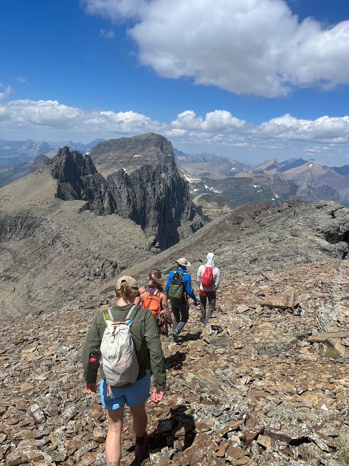 The pika crew walking the long ridge between Pollock Mountain and Bishop’s Cap above the Garden Wall in Glacier National Park, Montana.
