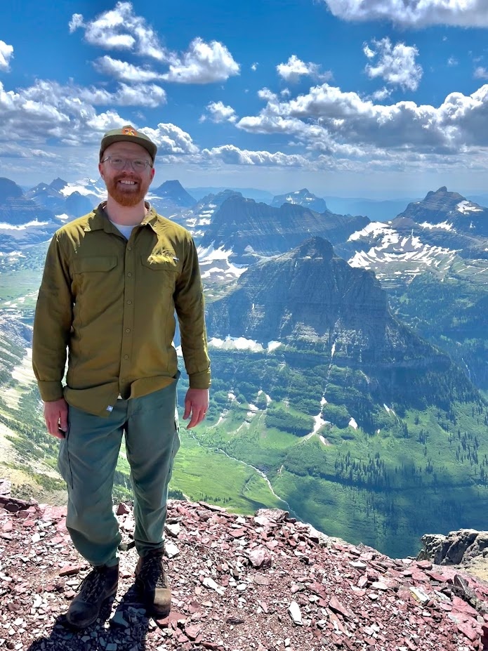 Gavin poses at the summit of Bishop’s Cap in Glacier National Park, Montana.