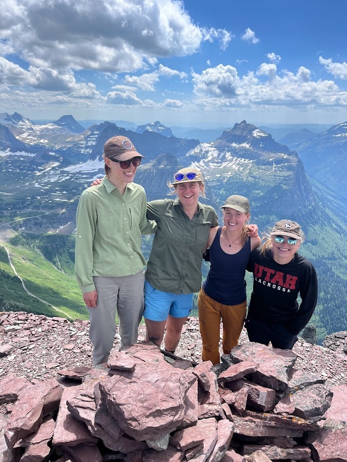 Jessalyn Ayars, Maloree Barbera, Dani Owens, and Lexie Bingman pause for a photo at the summit of Bishop’s Cap in Glacier National Park, Montana.