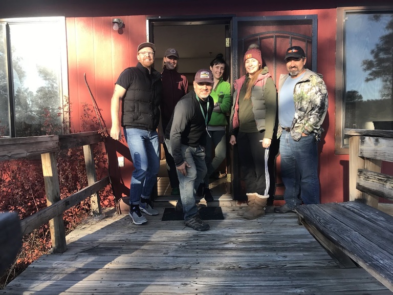 Gavin, Jessalyn Ayars, Jack Williams, Paige Handley, Andrea Chavez, and Rene Guaderrama pose in front of housing quarters during a field trip to the Gila National Forest.