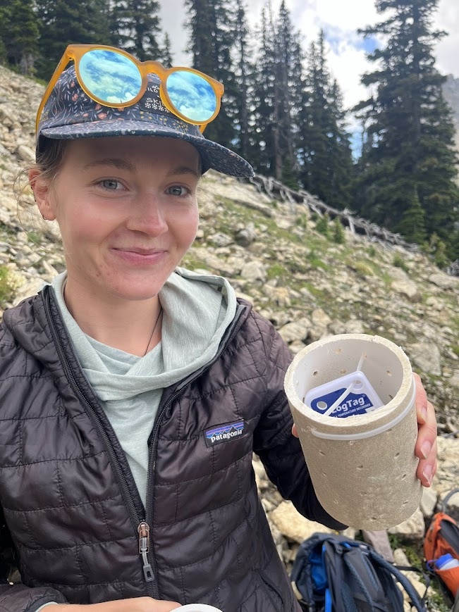 Dani Owens prepares to deploy a microclimate sensor in a talus patch to understand pika thermal exposure in Glacier National Park.