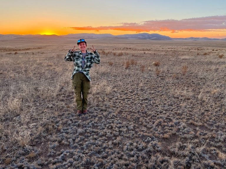 Dana poses with a beautiful sunset in one of the most remote areas of New Mexico.